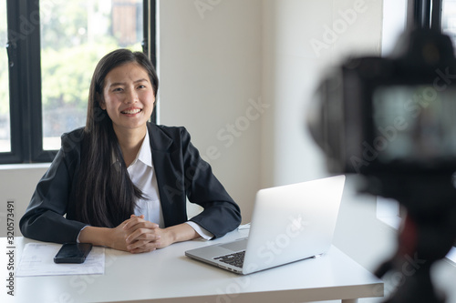 Influencer and content creator in digital marketing concepts. Young woman adjusting her digital camera prepare for record video content to her channel.