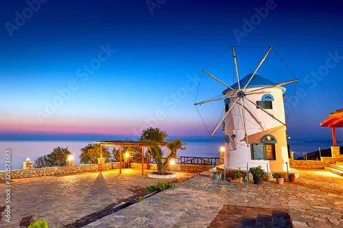 Traditional Wind Mills in Greece, Zakynthos Island. Incredibly romantic sunrise on Zakinthos. Amazing sunset view on old mill with multicolored clouds. Old Windmill in Agios Nikolaos near blue caves.