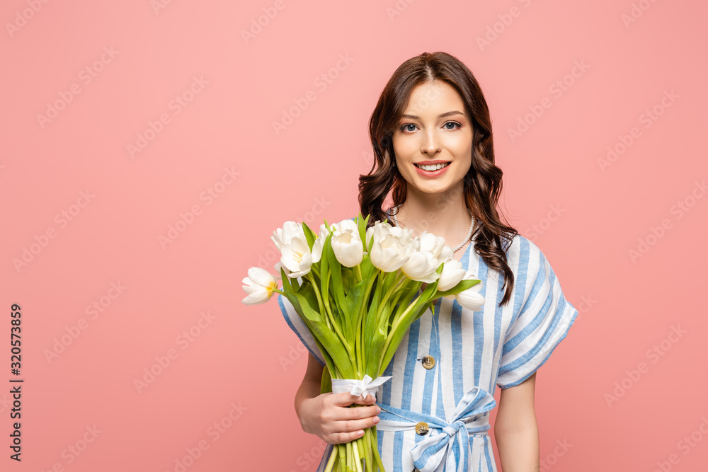 cheerful girl smiling at camera while holding bouquet of white tulips isolated on pink cheerful girl smiling at camera while holding bouquet of white tulips isolated on pink