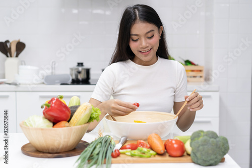 Eat healthy food for good wellness health concept. Woman cooking salad menu with fresh organic vegetables
