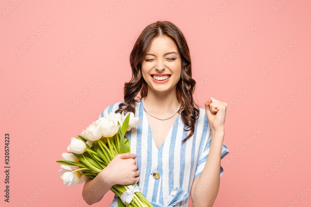 excited girl showing yeah gesture while holding bouquet of white tulips isolated on pink excited girl showing yeah gesture while holding bouquet of white tulips isolated on pink