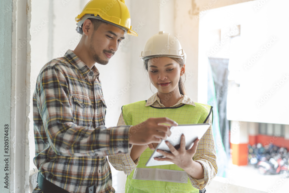 Asian contractor and engineer inspecting material in construction building. Asian contractor and engineer inspecting material in construction building.