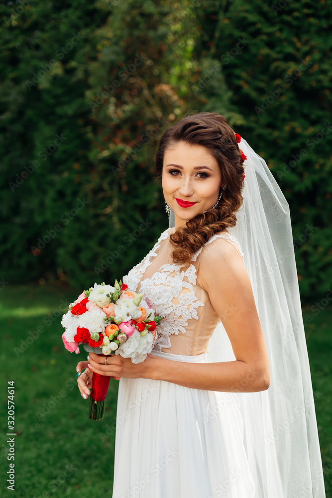 bride with wedding bouquet in elegant wedding dress looks into c bride with wedding bouquet in elegant wedding dress looks into c