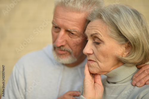 Close up portrait of sad thoughtful senior couple 