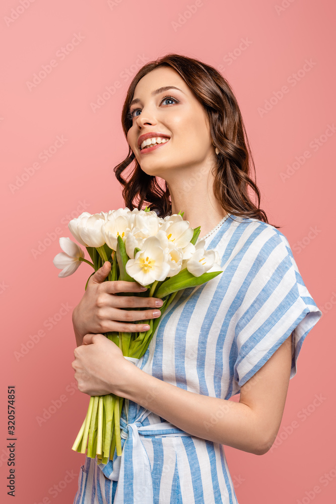 happy girl looking up while holding bouquet of white tulips isolated on pink happy girl looking up while holding bouquet of white tulips isolated on pink