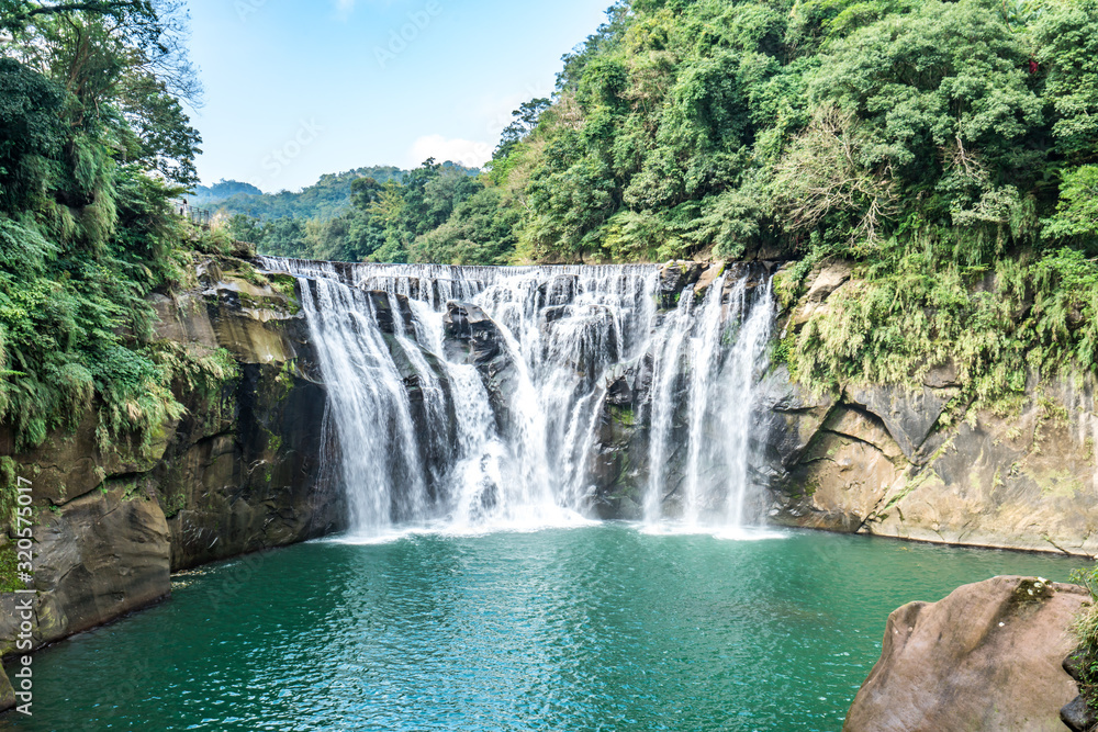 Fototapeta premium Shihfen Waterfall, Fifteen meters tall and 30 meters wide, It is the largest curtain-type waterfall in Taiwan