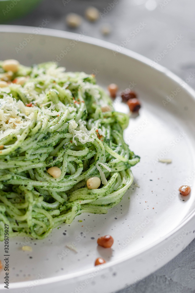 Green pasta with avocado, spinach and pine nuts