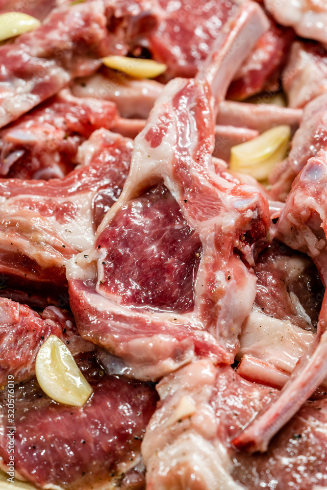 Raw Meat Marinated Lamb Chops on Tray / Marinating Before Cooking. Raw Meat Marinated Lamb Chops on Tray / Marinating Before Cooking.