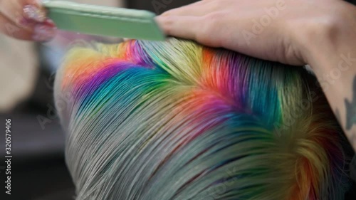 Coloring hair in a barbershop. Multicolored dyeing. A short pixie haircut.