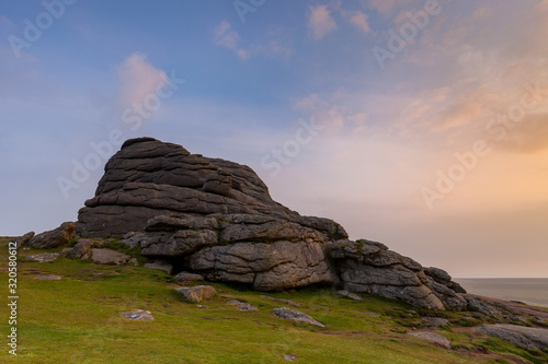 A view of Haytor, a large granite rock formation on Dartmoor national park. taken at sunrise.
