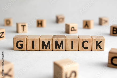 Gimmick - words from wooden blocks with letters, gimmick concept, white background