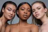 Three multiracial young women with different types of skin.