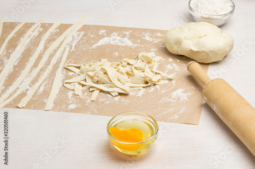 Rolling pin and dough cut into strips