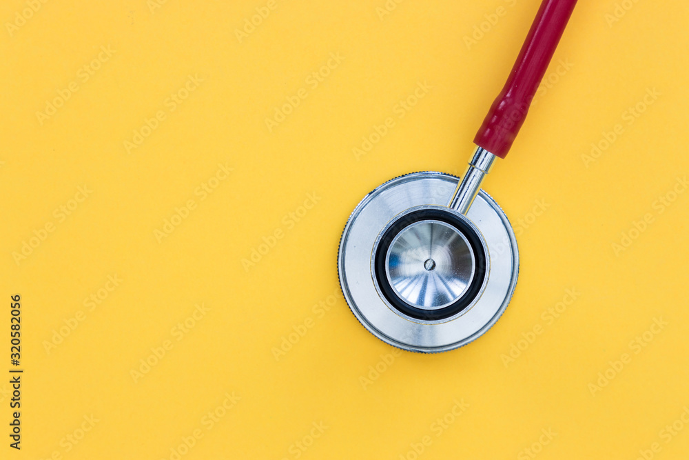 Red stethoscope on yellow background top view minimal doctor health concept Red stethoscope on yellow background top view minimal doctor health concept