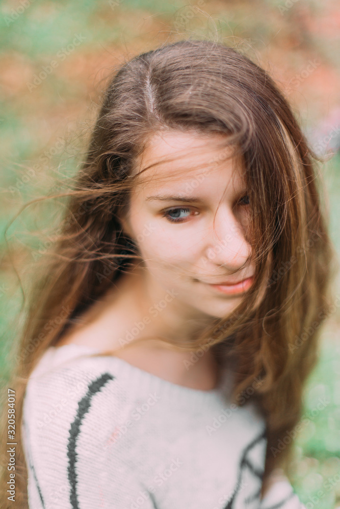 Fototapeta premium beautiful woman with flowers walking through the green forest in early spring