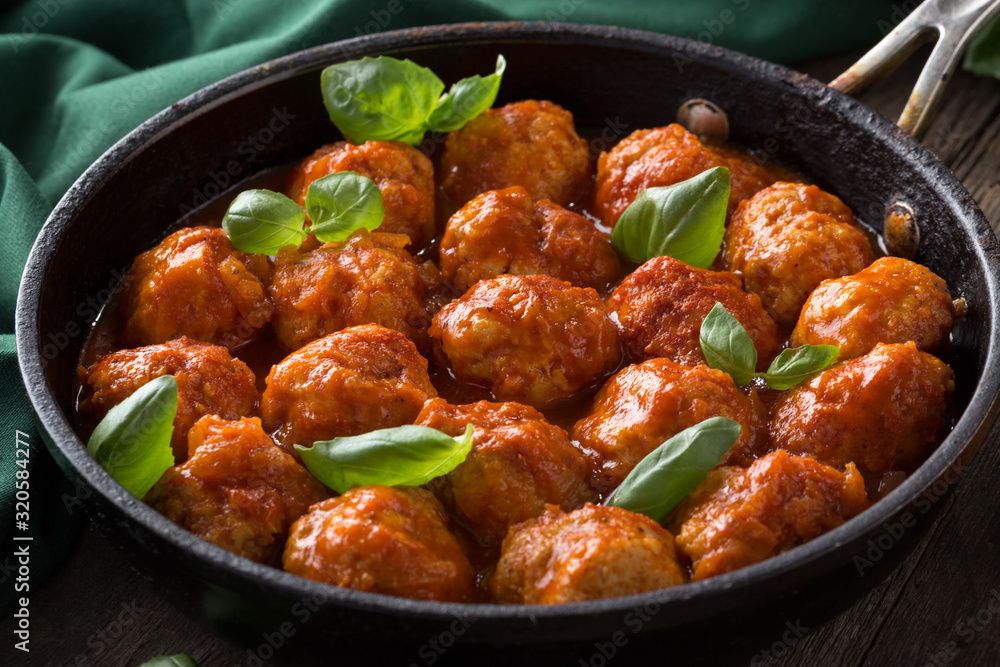 Traditional italian Meatballs served on a old wooden table. Meatballs served on a old wooden table with green napkin and spoon. Homemade delicious italian Meatballs on on a rustic table for dinner. it Traditional italian Meatballs served on a old wooden table. Meatballs served on a old wooden table with green napkin and spoon. Homemade delicious italian Meatballs on on a rustic table for dinner. it