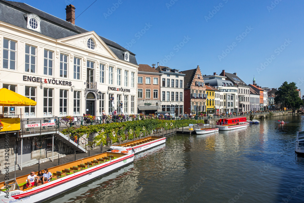 The river Leie / Lys and restaurants and sightseeing boats along the Kraanlei / Crane Lane in the city Ghent / Gent, East Flanders, Belgium