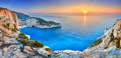Fototapeta Naklejka Na Ścianę i Meble -  Navagio Beach with shipwreck view on Zakynthos island, Greece. Incredibly romantic sunrise on Zakinthos. Amazing sunset view with multicolored clouds. Island of lovers. Doors to heaven