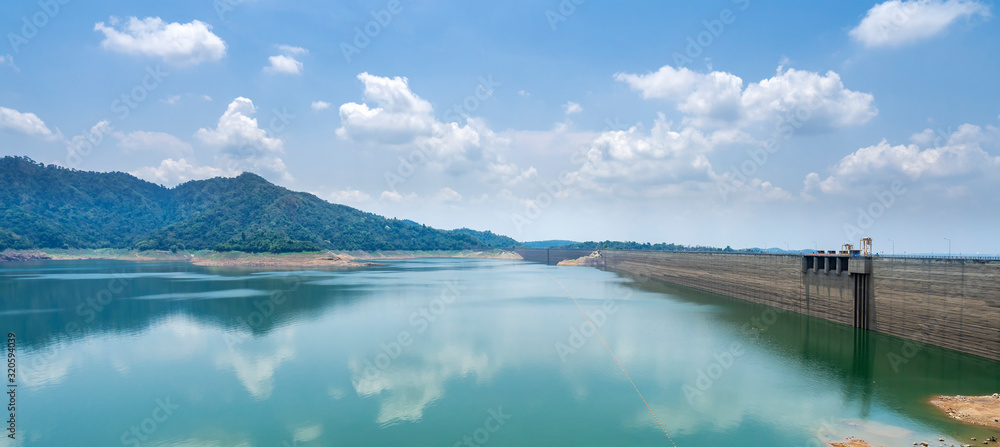 Beautiful view water in lake with large wall or high ridge with blue cloudy sky and behind khun dan prakan chon dam in nakhon nayok province thailand