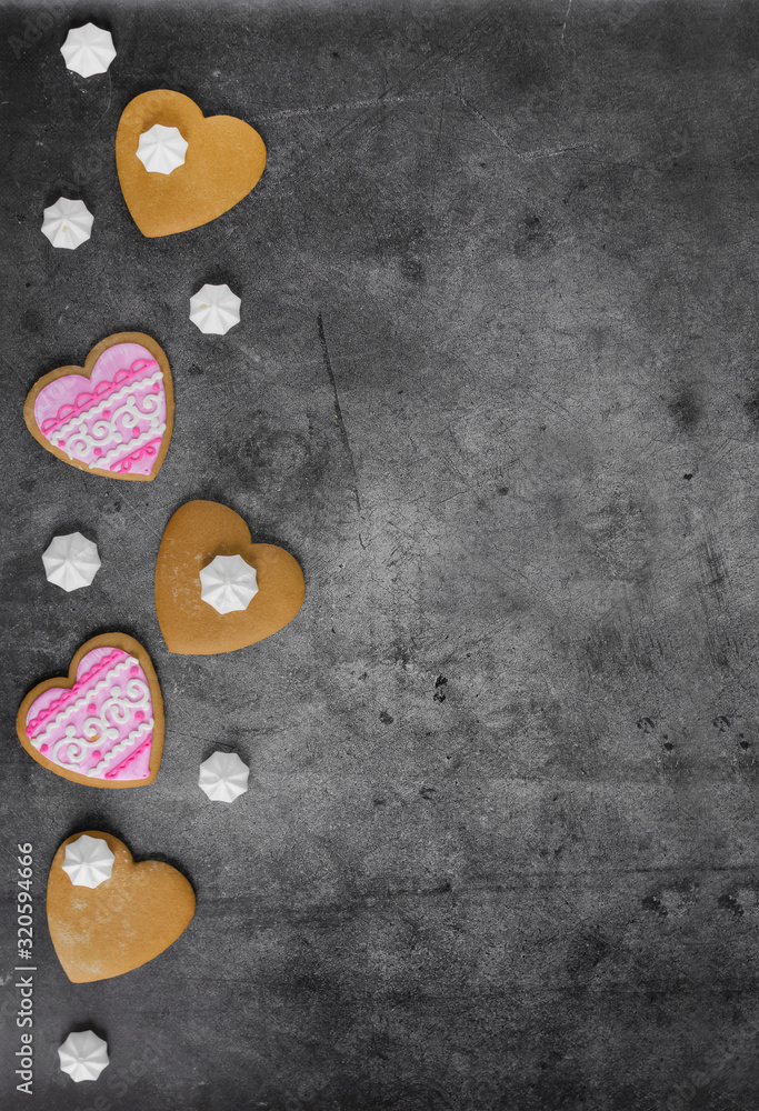 Fototapeta premium Mother's Day, Valentine's Day, Women's day.Banner of gingerbread hearts on a dark stone background with space for text.Poster for sale in the store.Postcard favorite..Spring festival.vertical