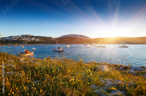 Fishing boats in the morning light. Sunrise on Nuevo Loca Beach. Traveling concept background. Palaia Fokaia location. Greece, Europe. Sunny morning seascape. Spring on the Greek coast Aegean sea photo