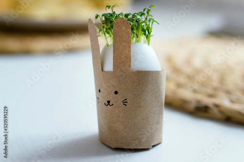 Easter bunny with green cress salad in an egg