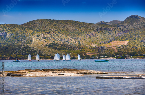 Sailing (windsurfing) in the morning light. Sunrise on Nuevo Loca Beach. Traveling concept background. Palaia Fokaia location. Greece, Europe. Sunny seascape. Spring on the Greek coast Aegean sea photo