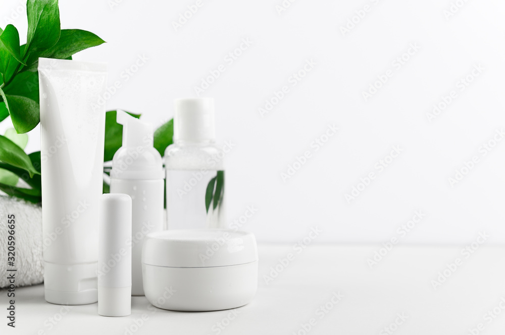 Set of packages of organic cosmetics for face and body care on white background. Cream, shampoo, lotion and lipstick in a composition on a light backdrop. Skin, lips and hair care. Mockup, copy space Set of packages of organic cosmetics for face and body care on white background. Cream, shampoo, lotion and lipstick in a composition on a light backdrop. Skin, lips and hair care. Mockup, copy space