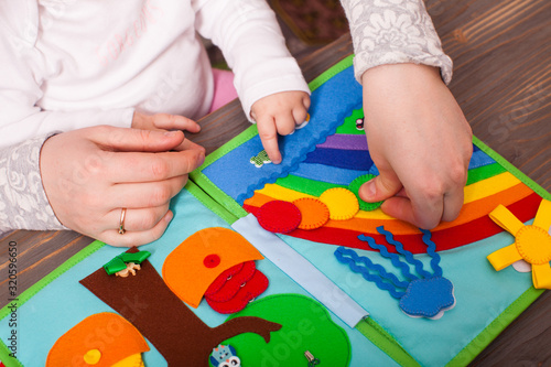 Tutor with toddler are learning the colors of the rainbow