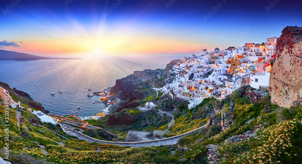 Fira town on Santorini island, Greece. Incredibly romantic sunset on Santorini. Oia village in the morning light. Amazing sunset view with white houses. Island lovers. Panorama of the bay. Santorini