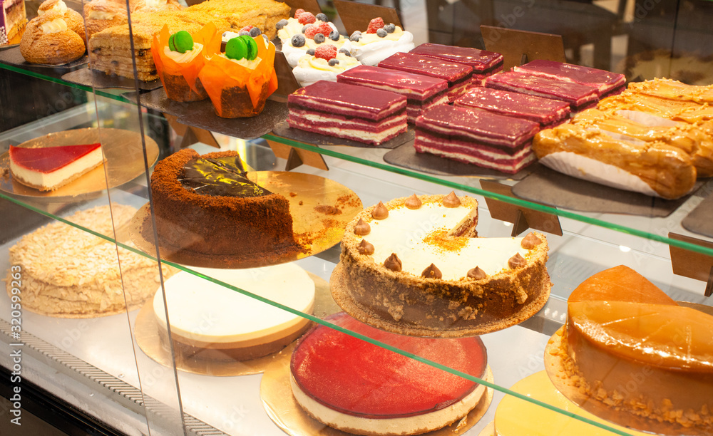 Fototapeta premium Showcase with cakes, pastries, biscuits. Small business