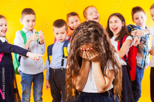 Fotografie School girl being bullied by classmates. School bullying concept