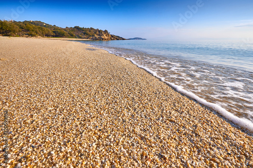 Fototapeta Naklejka Na Ścianę i Meble -  Amazing sunset view on Proti ammoudia beach near Olympiada town summer resort, Kavala region, Greece.. Incredibly romantic sunrise on the beach, Ionian Sea. View of the ocean. Tropical beach
