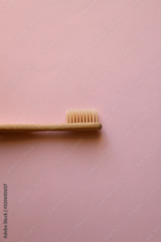 Bamboo toothbrush on pale pink background. Zero waste lifestyle concept. Flat lay. Bamboo toothbrush on pale pink background. Zero waste lifestyle concept. Flat lay.