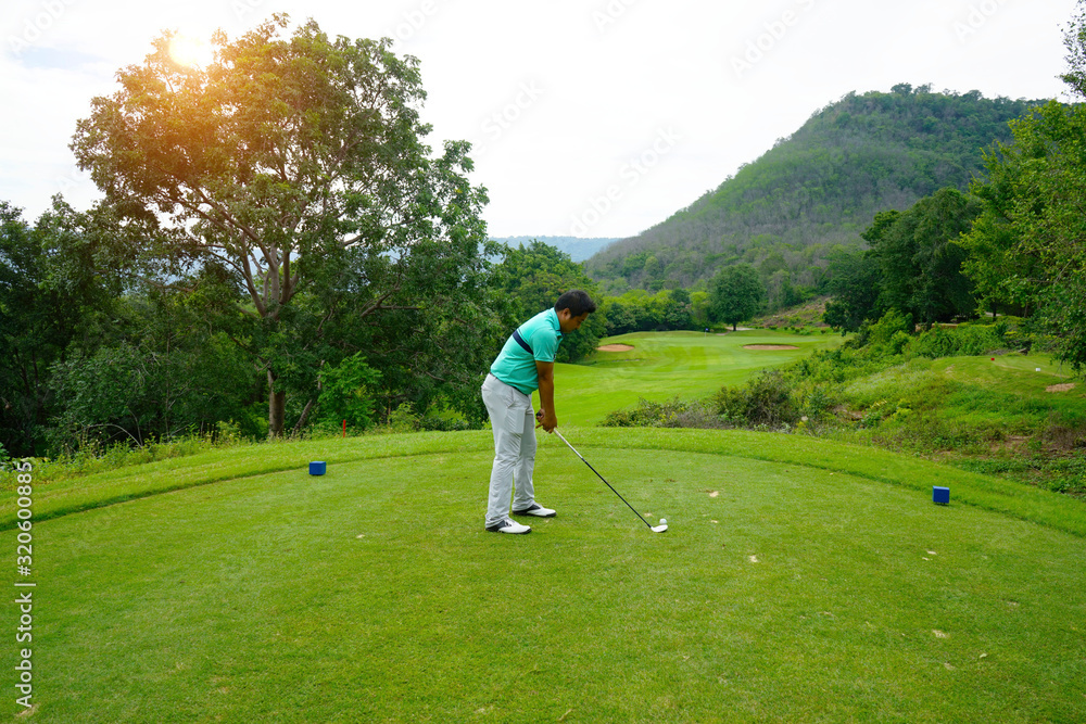 Fototapeta premium Blurred golfer playing golf in beautiful golf course in the evening golf course with sunshine in thailand