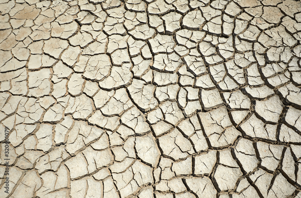 Drought land. Cracked clay ground . Drought, ground cracks, no water, lack of moisture. Global worming effect. Crack soil on dry season. Abstract natural background with cracked earth texture. Drought land. Cracked clay ground . Drought, ground cracks, no water, lack of moisture. Global worming effect. Crack soil on dry season. Abstract natural background with cracked earth texture.