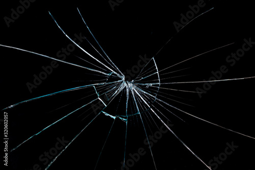 crack on the broken glass mirror on a black background chipped