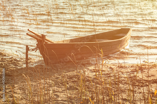 Boat moored on the mudy shore lake photo