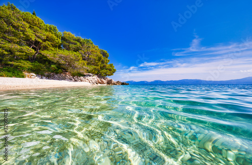 Amazing seascape of Adriatic sea. Luchica beach Croatia, Europe. Colorful summer view of small beach. Croatian coast with clear water and pine trees around. Tropical viewpoint for design postcard.