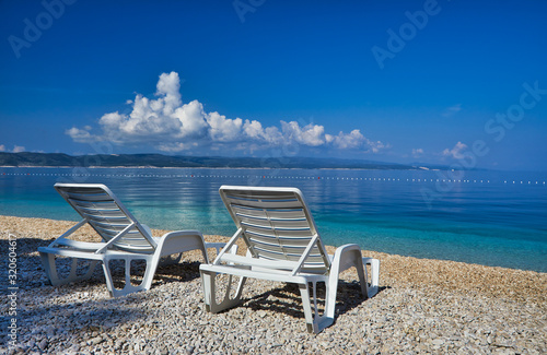 Amazing seascape of Adriatic sea. Colorful summer view of small Brela beach Croatia, Europe. Croatian coast with clear water and pine trees around. Tropical viewpoint for design postcard.