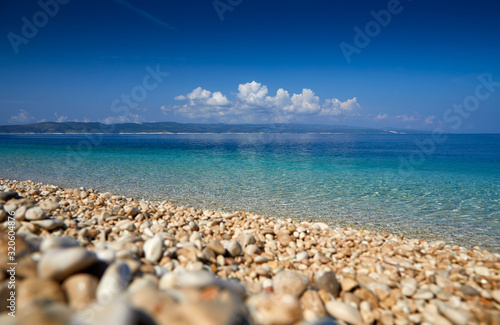 Amazing seascape of Adriatic sea. Colorful summer view of small Brela beach Croatia, Europe. Croatian coast with clear water and pine trees around. Tropical viewpoint for design postcard.
