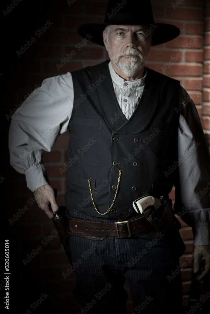 1885 old west cowboy ready to draw his pistol medium shot Stock Photo