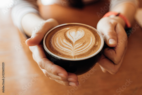 Close up Cup of coffee latte in coffee shop Fototapeta