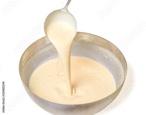 Kneading dough for pancakes. Batter for pancakes is poured from a large spoon