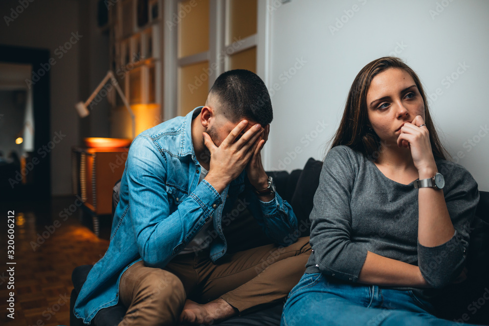 young couple arguing in living room. relationship problems young couple arguing in living room. relationship problems