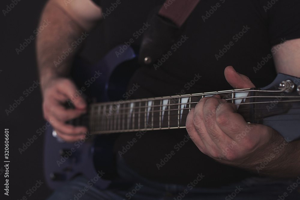 Fototapeta premium the guy plays the electric guitar