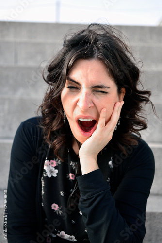 Young and beautiful woman yawning