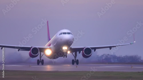 Airplane (aircraft) taking off at dusk photo