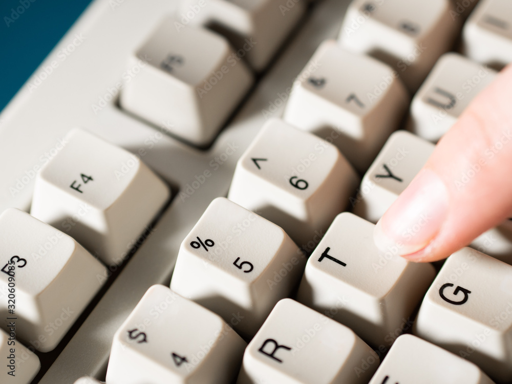 Female forefinger pushes T button. Close-up Female forefinger pushes T button. Close-up