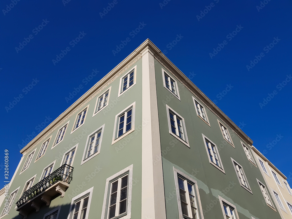 Building facade corner against blue sky Building facade corner against blue sky